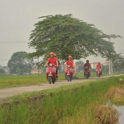 “Journey through Vietnam’s rural soul — quiet dirt roads, open rice fields, and smiling villagers waving from doorways.”